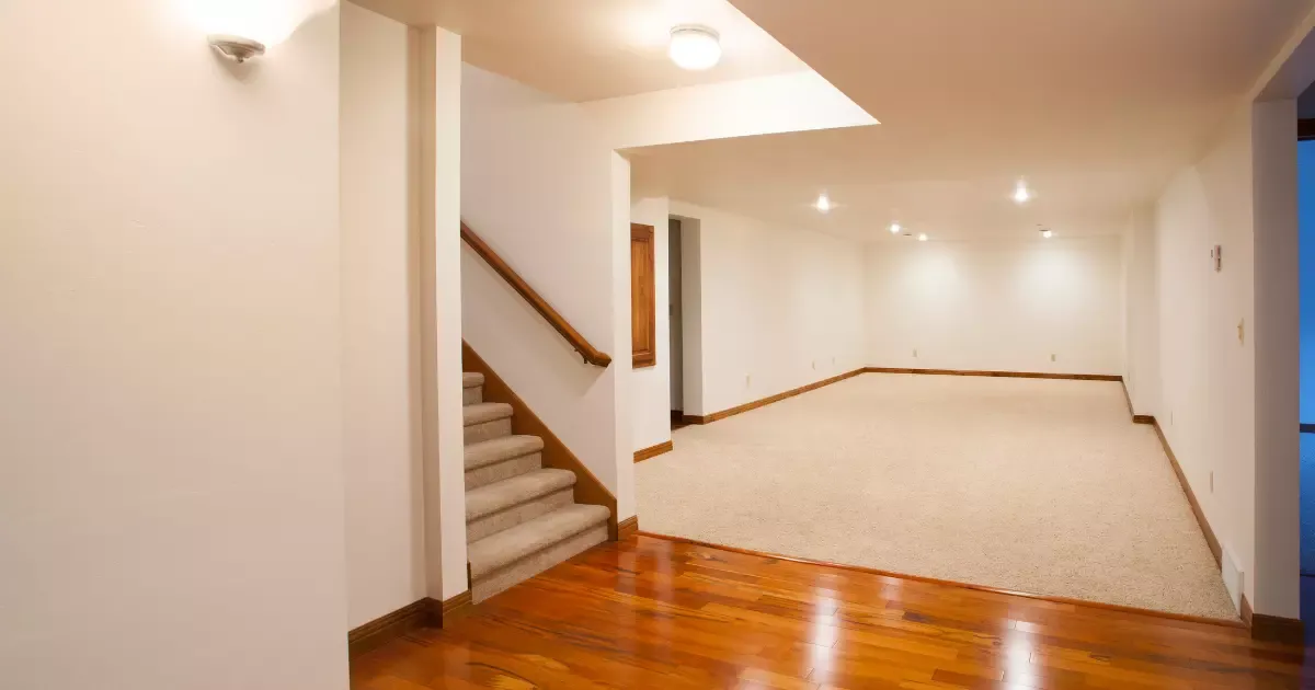 Spacious unfinished basement with stairs and open layout, ready for basement remodeling