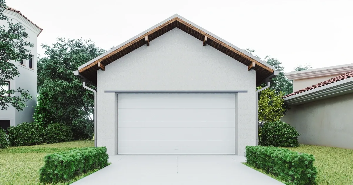 Modern single garage apartment with white exterior and green surroundings