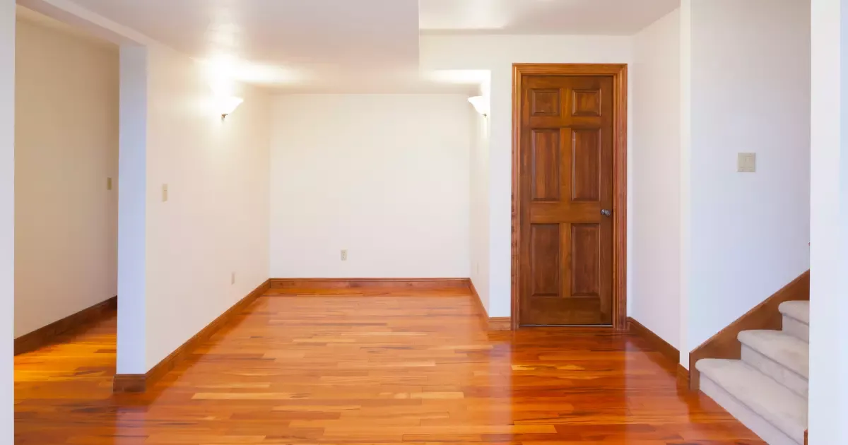 Open layout showcasing small basement design ideas with hardwood floors