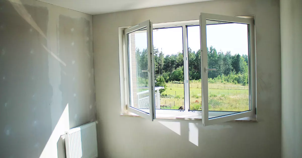 Unfinished room with drywall and open window letting in sunlight, part of a home addition project