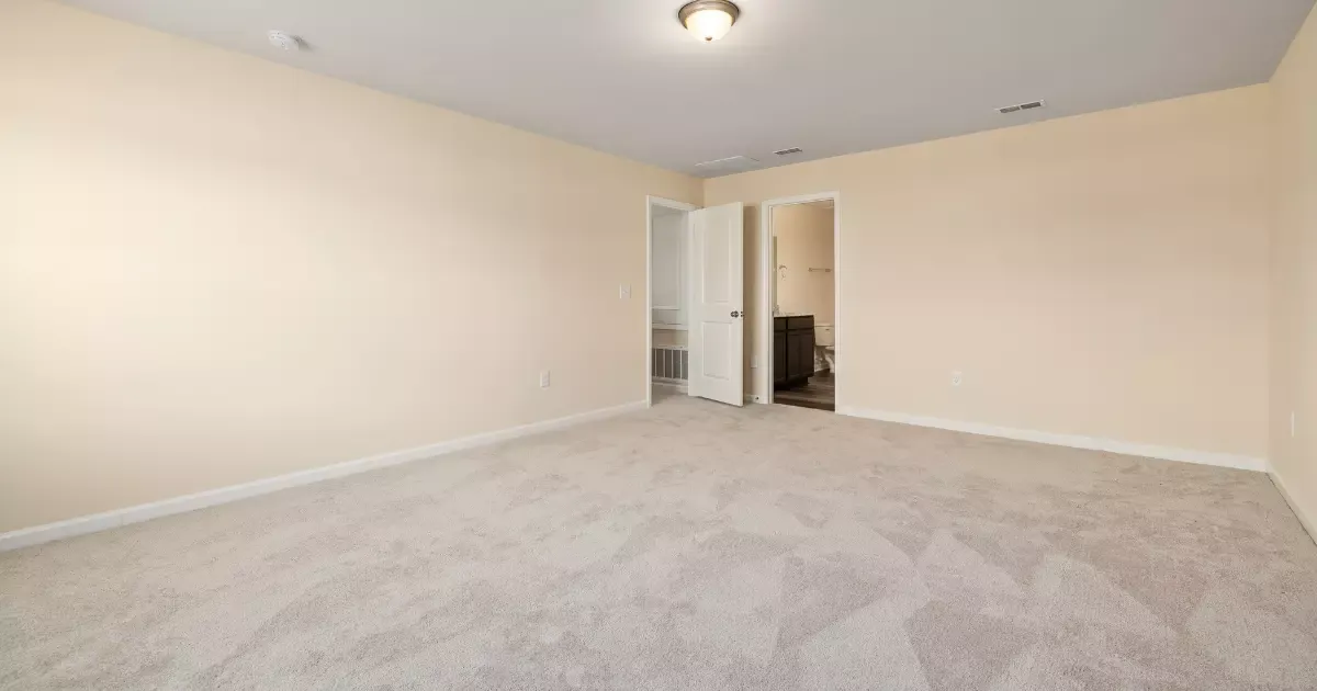 Cozy finished basement with wall-to-wall carpet basement flooring and soft neutral walls