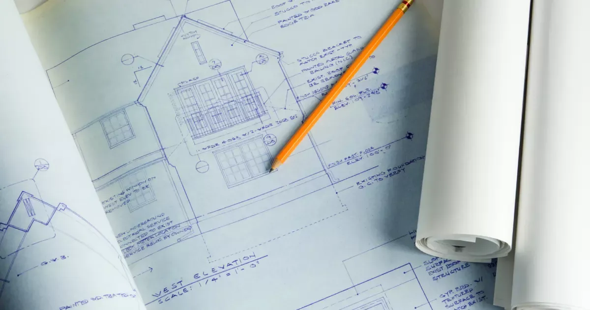 Architectural blueprints and pencil on plans for a home addition design project