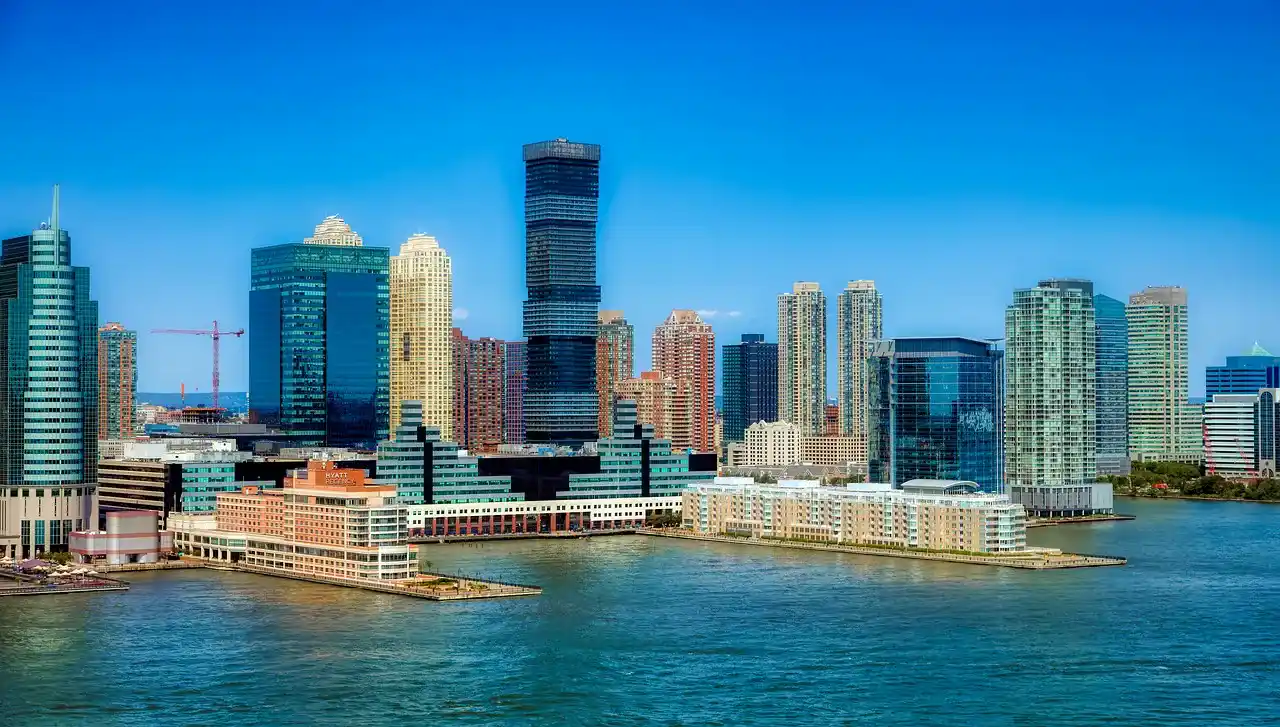 A city skyline is visible over a body of water.