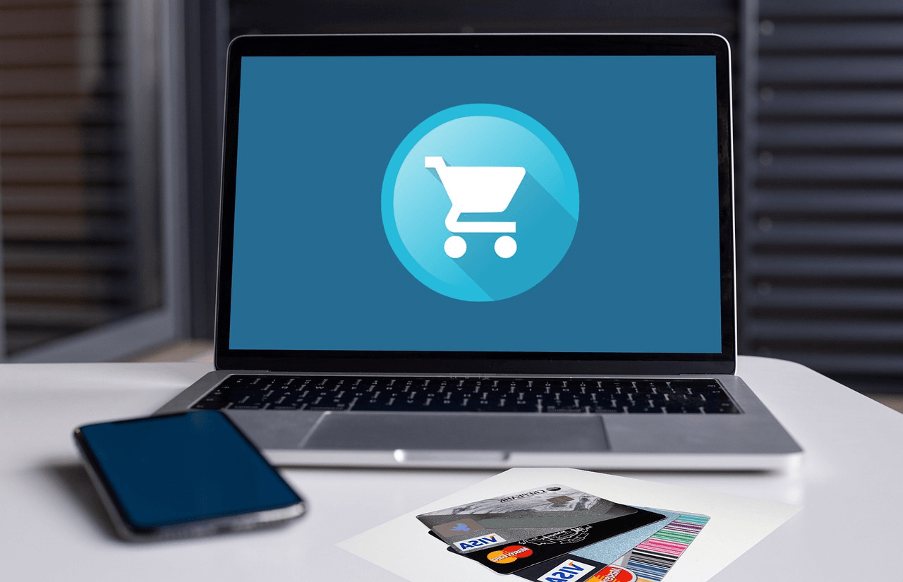 A laptop with a shopping cart icon on the screen
