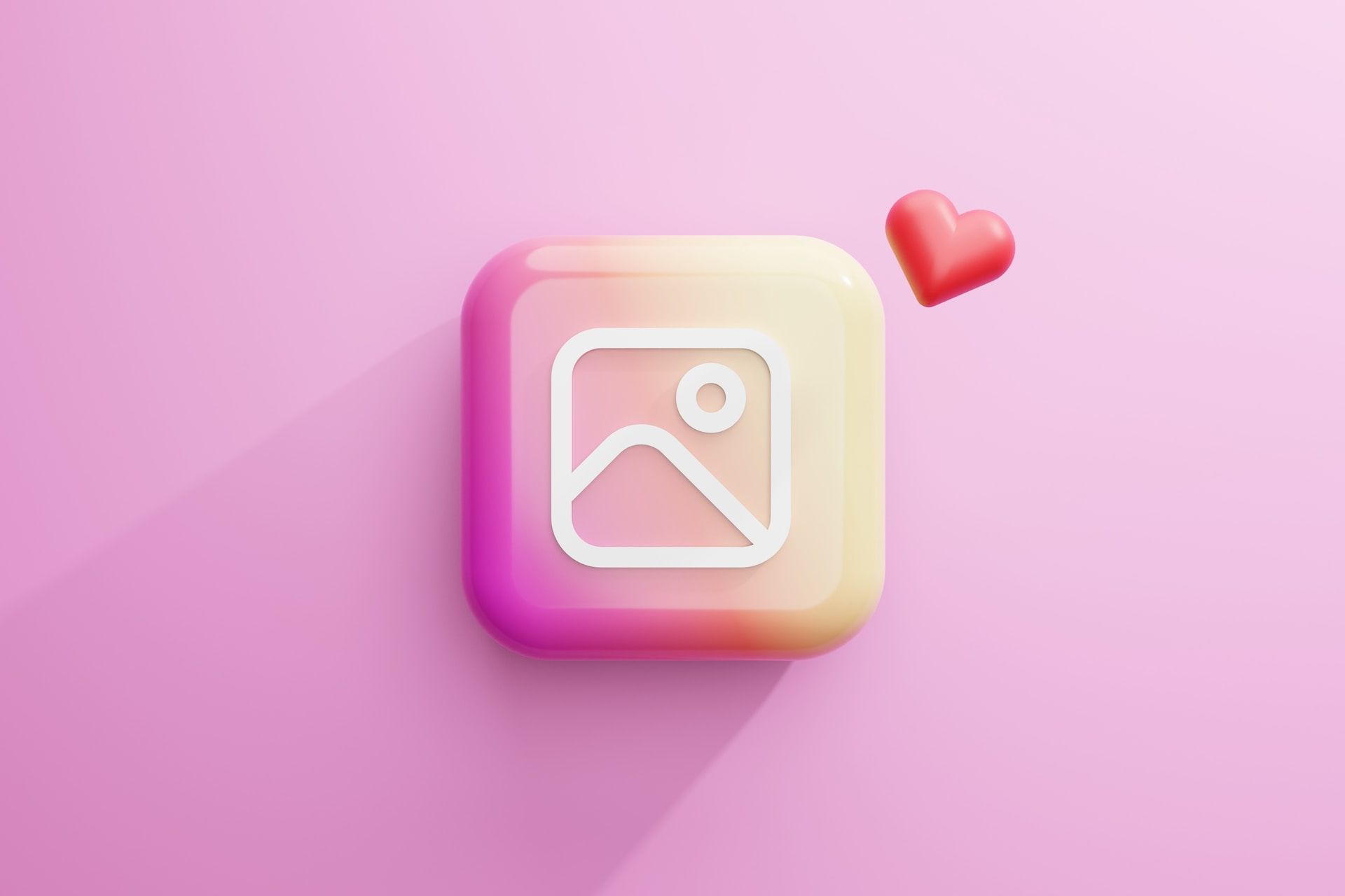 A square icon with a picture and a heart on a pink background.