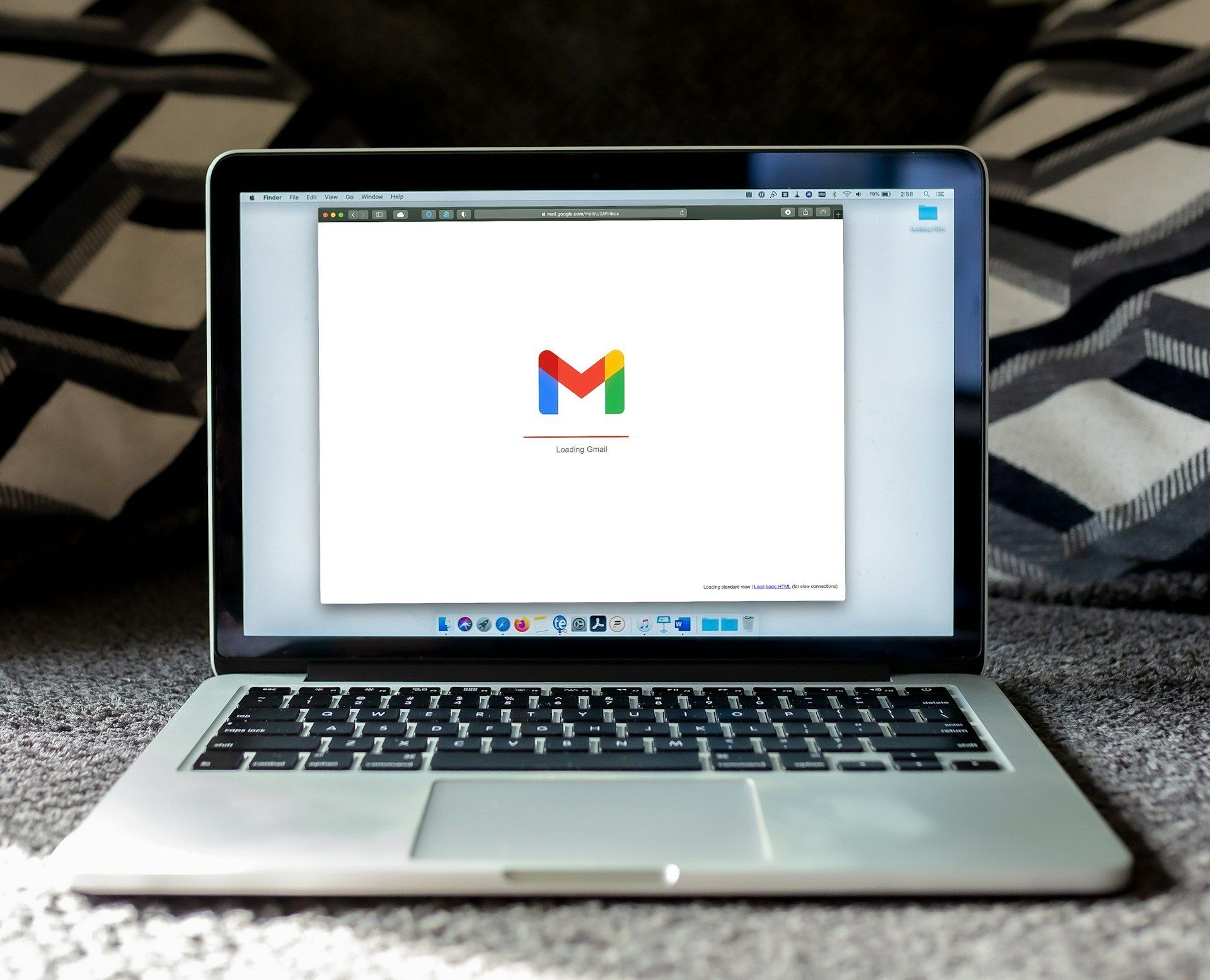 A laptop with the letter m on the screen