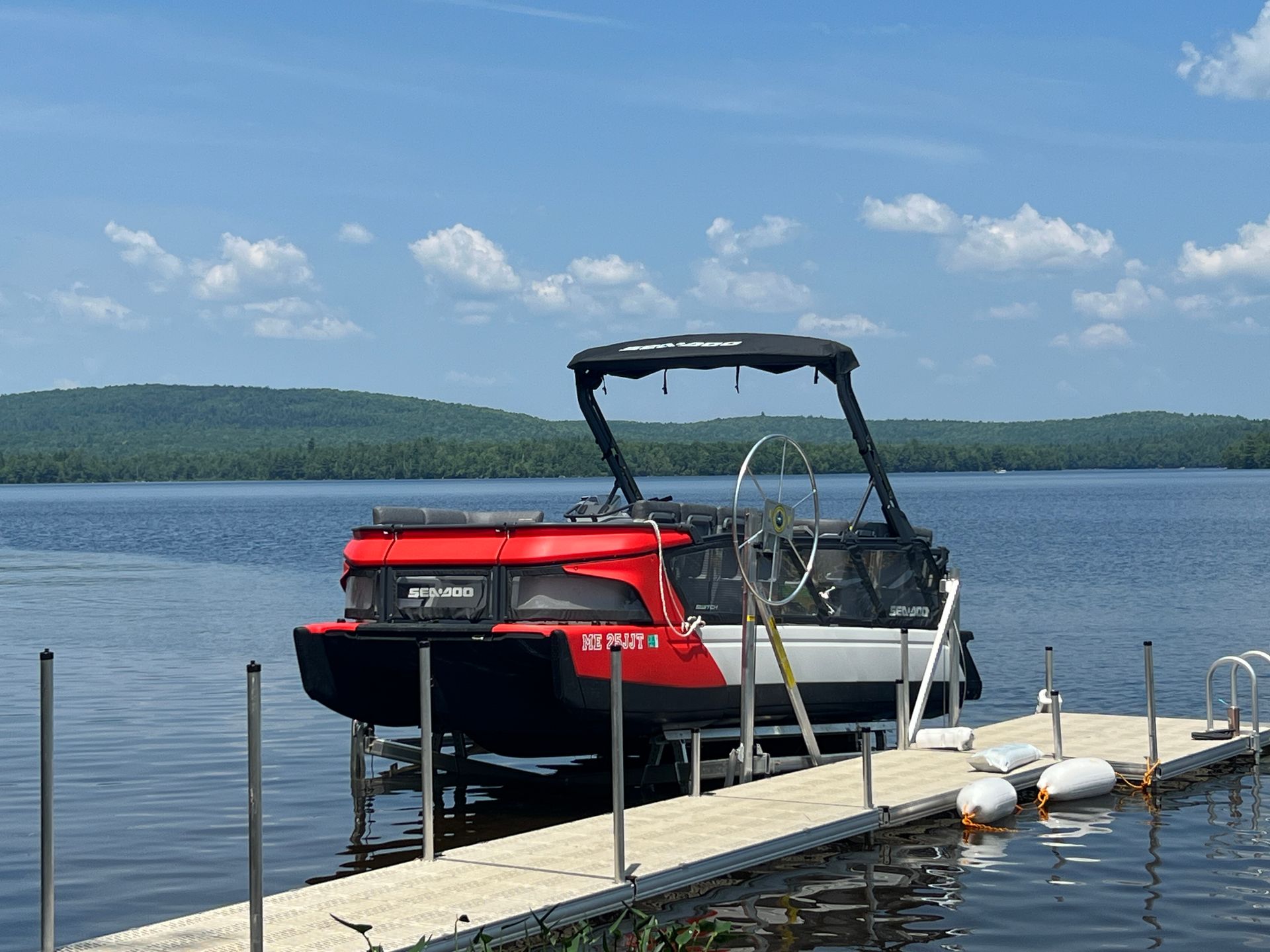 a boat is docked at a dock on a lake .