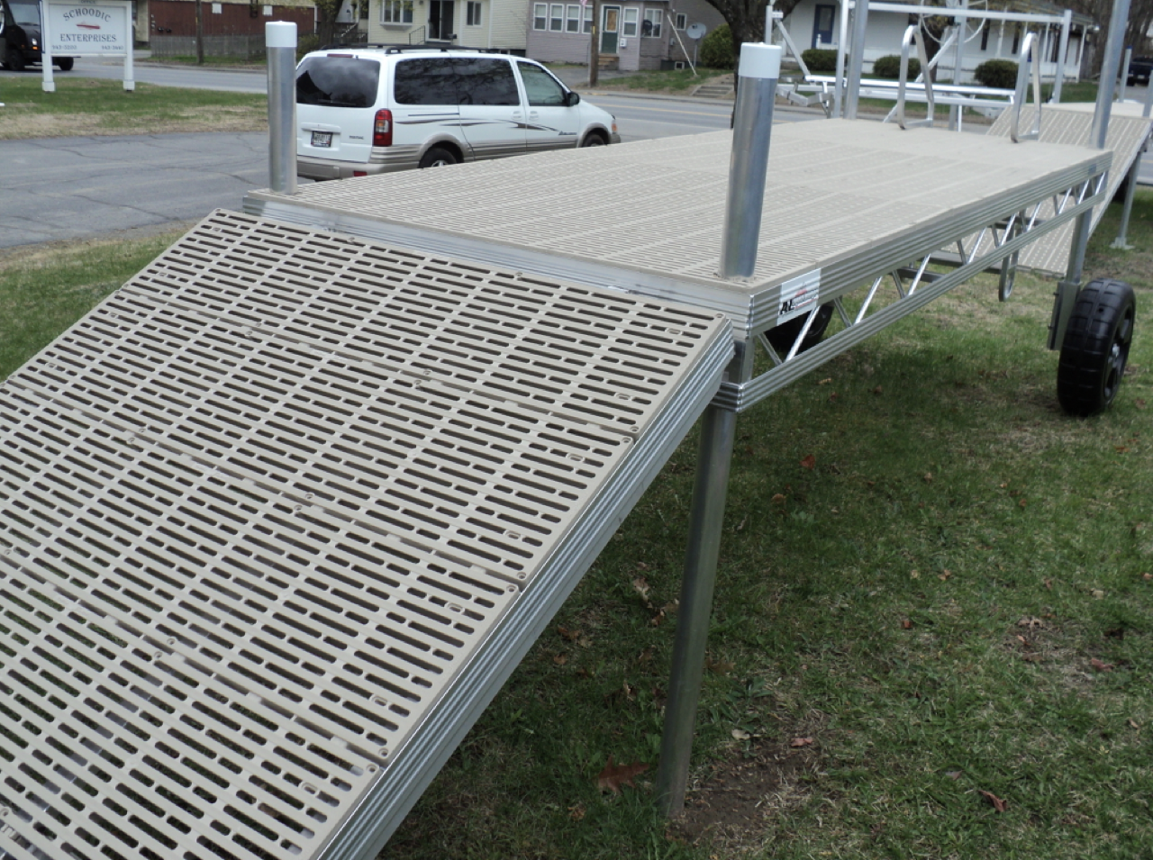 A white van is parked on the side of a dock