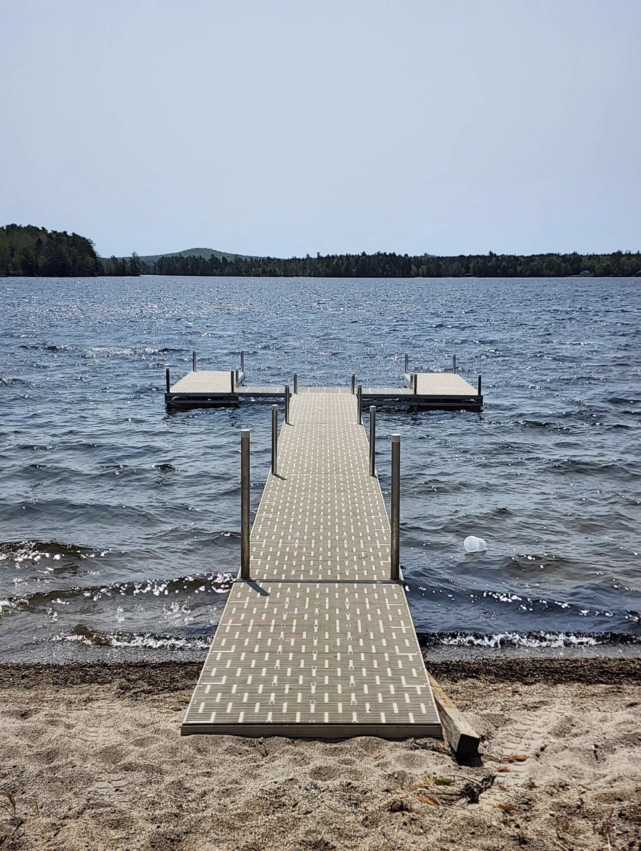 A dock leading into a large body of water.