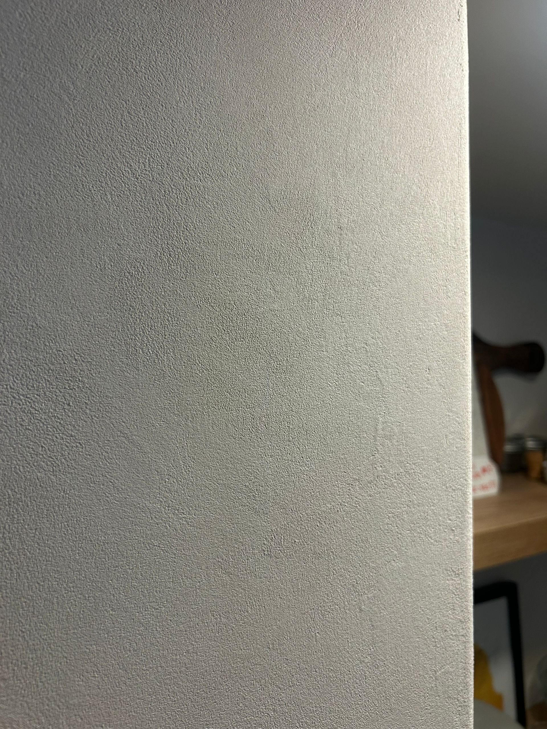 A close-up view of a frosted or sandblasted glass panel with a speckled, light-diffusing texture.