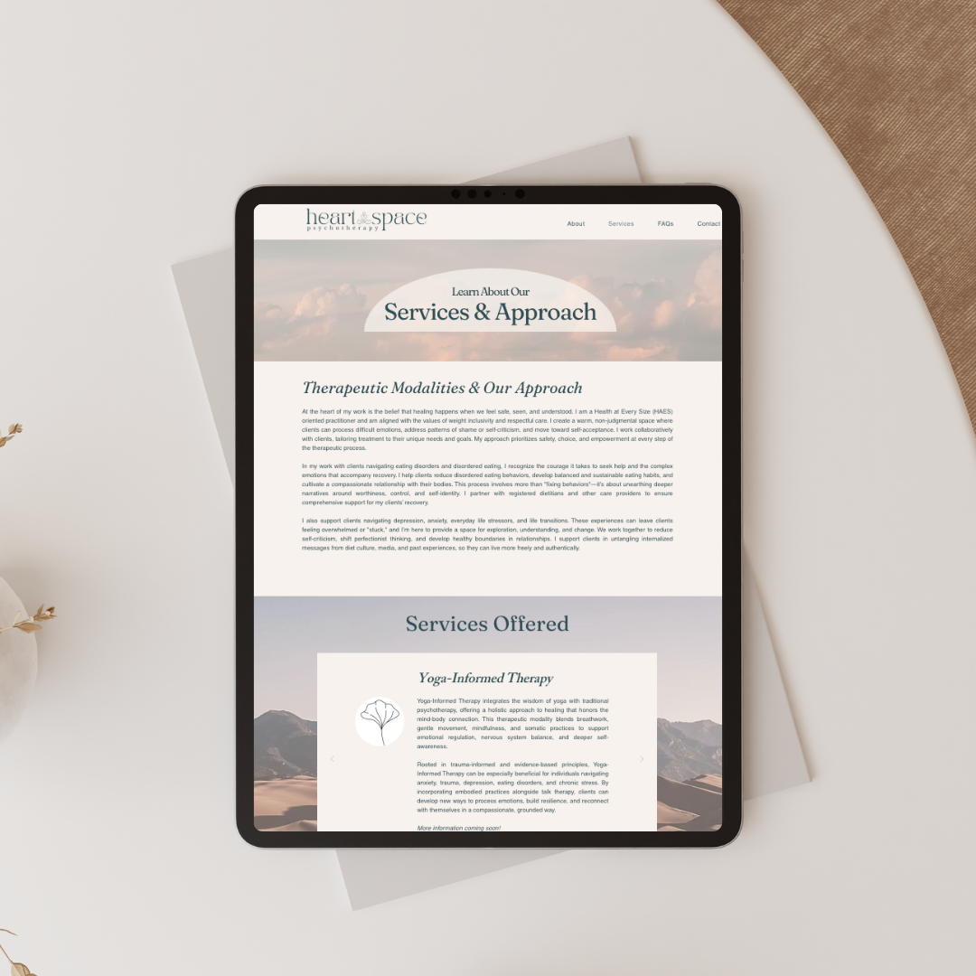 Tablet displaying a web page with a soft beige layout and a centered article section on a desk