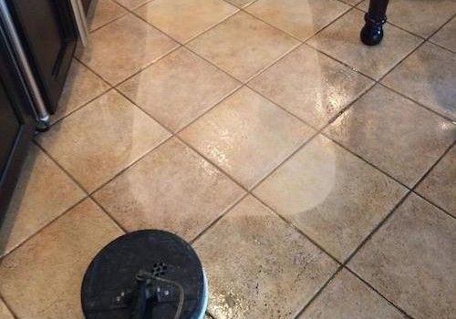 A vacuum cleaner is cleaning a carpet in a bedroom.