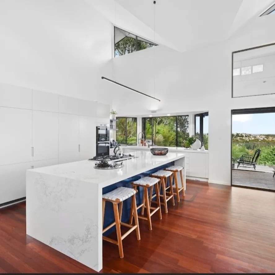 Large White and Navy Kitchen Island with Rattan Stools — DMB Kitchens in Port Macquarie, NSW