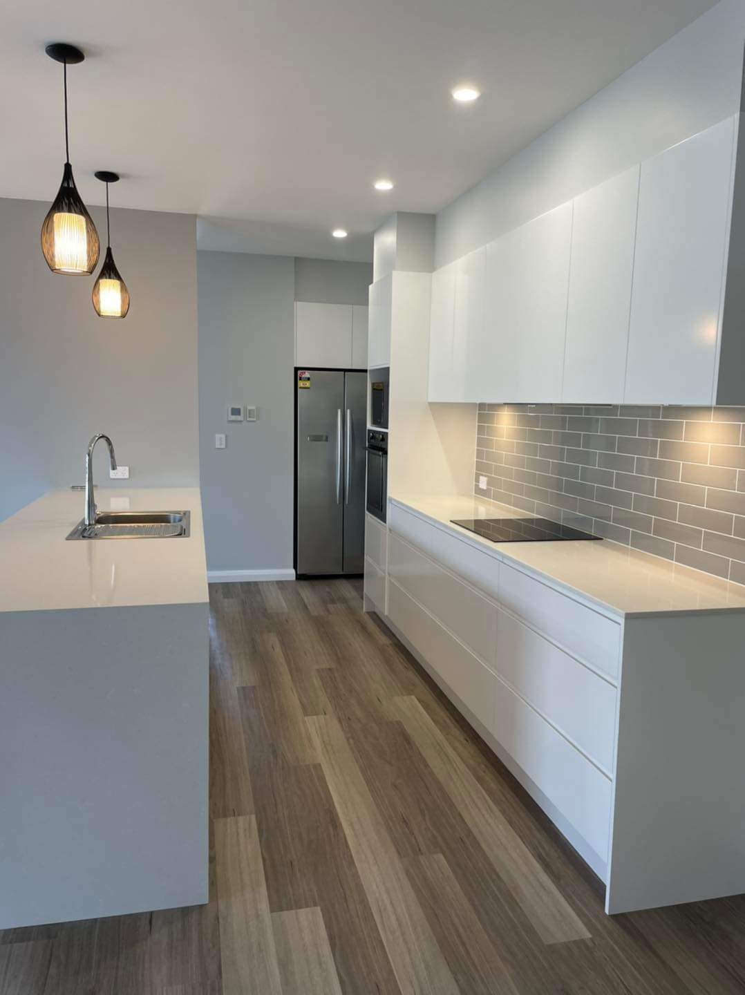 Large White and Kitchen Island with Black Pendant lighting  — DMB Kitchens in Port Macquarie, NSW