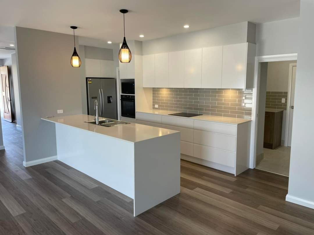 Large White and Kitchen Island with Black Pendant lighting  — DMB Kitchens in Port Macquarie, NSW