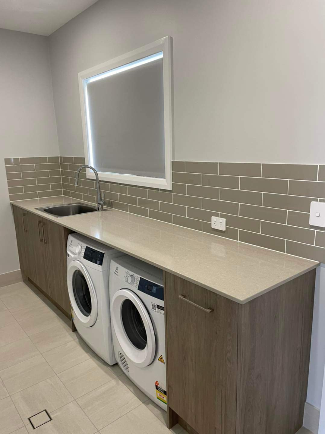 White and Brown Laundry With Washer and Dryer  — DMB Kitchens in Port Macquarie, NSW