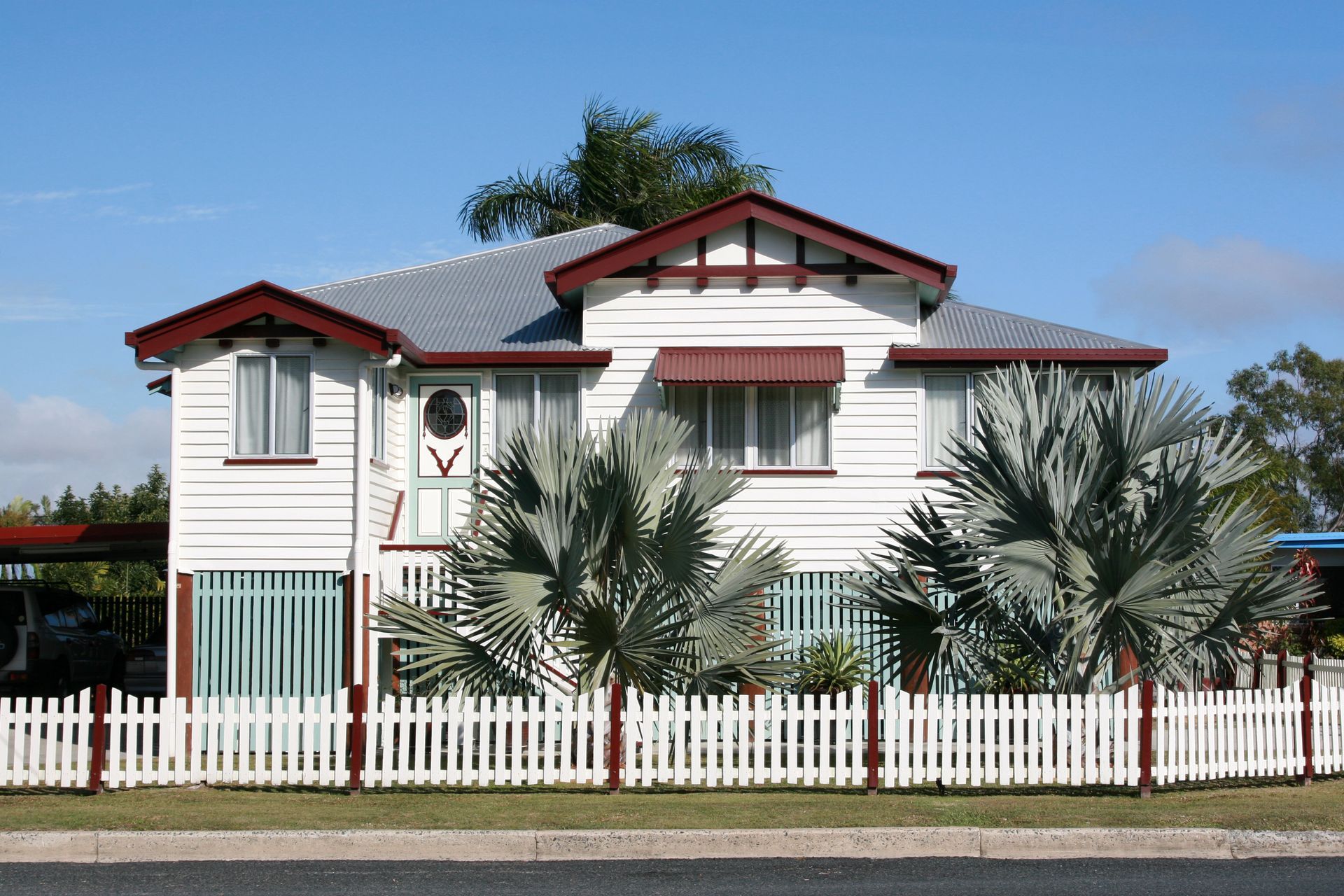 A white house with a white picket fence around it