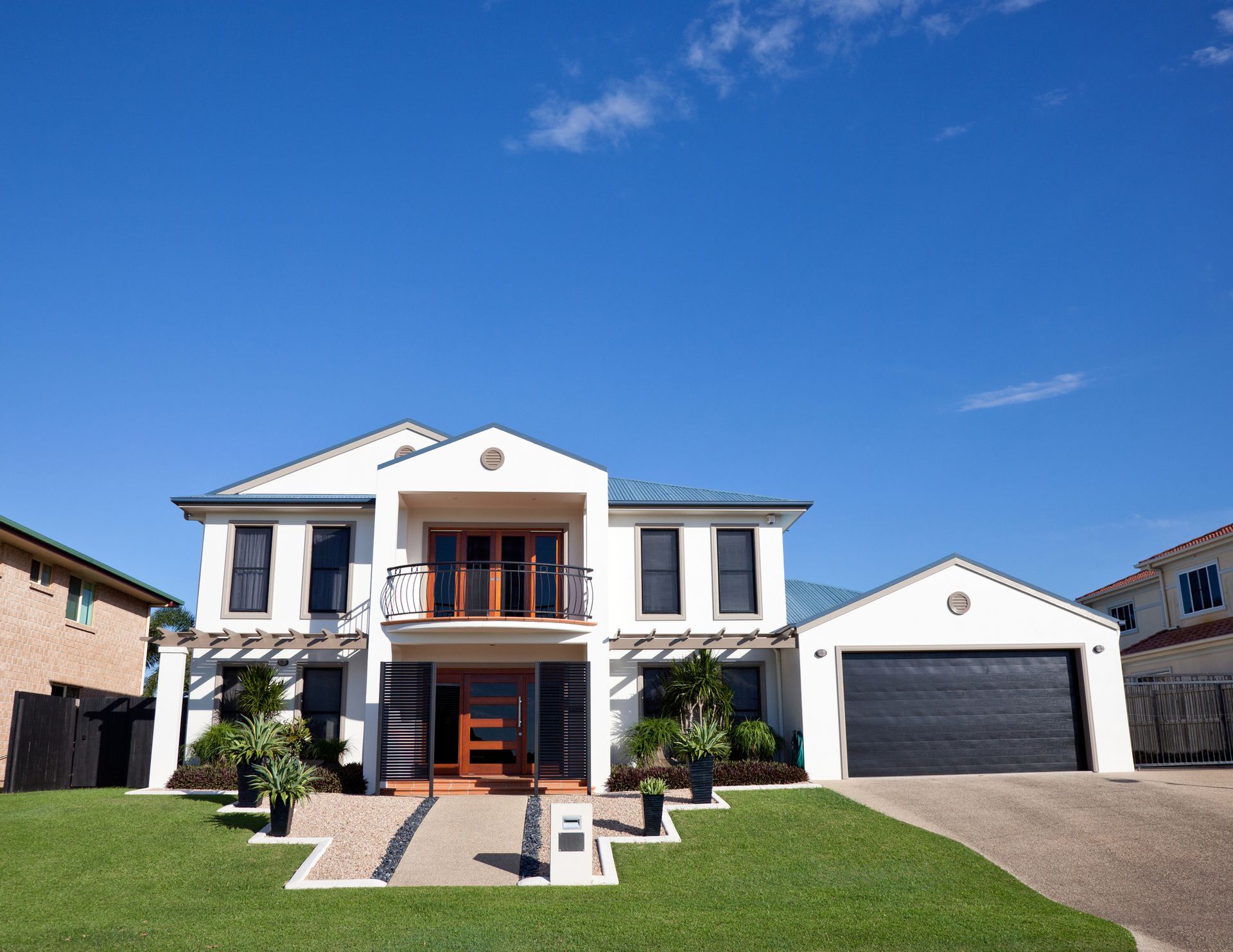 A large white house with a black garage door