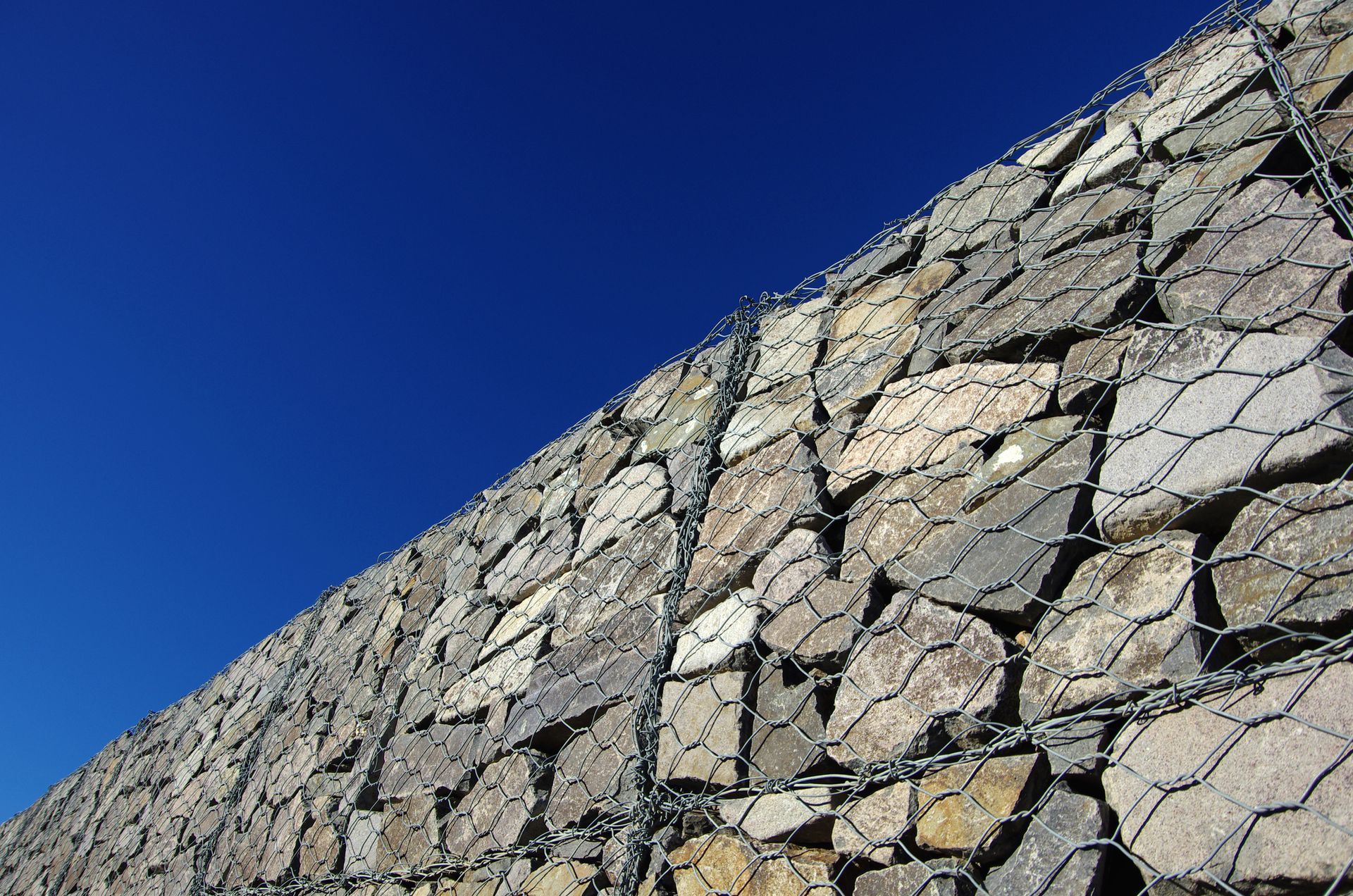 A stone wall with a blue sky in the background