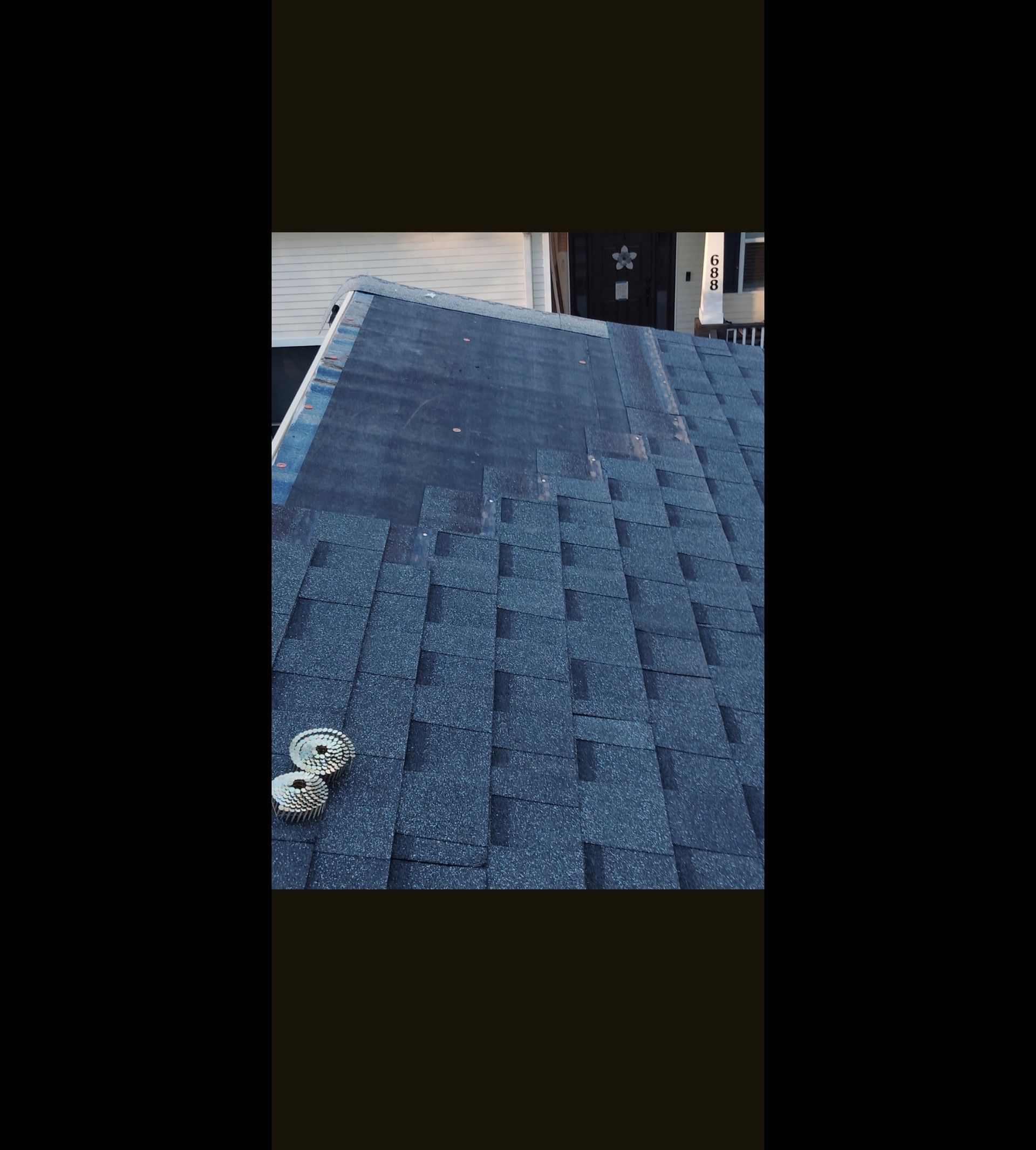 Blue shingled roof with a small white object near the bottom left.