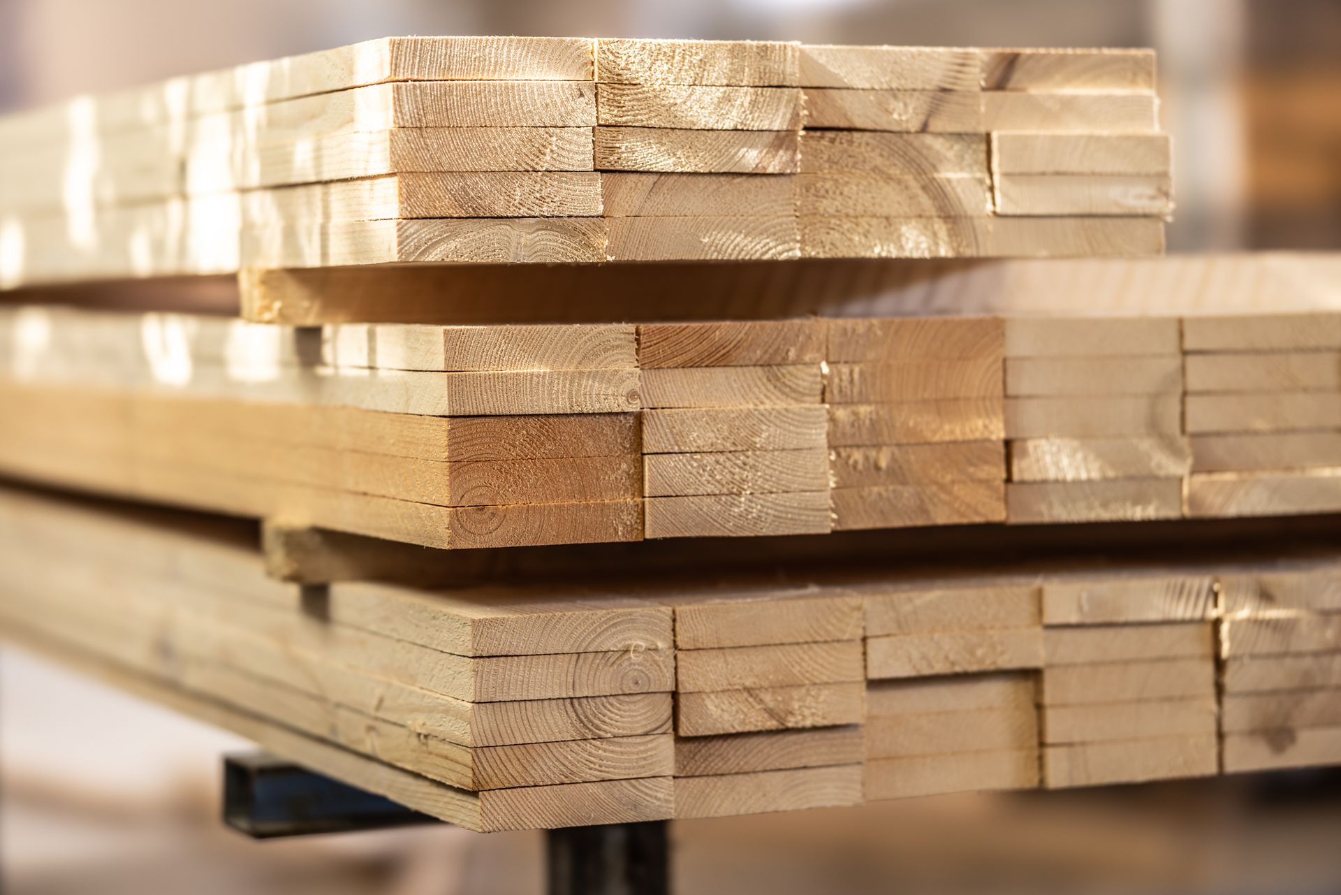 Stacked timber decking boards showing smooth surfaces and natural wood grain detail.