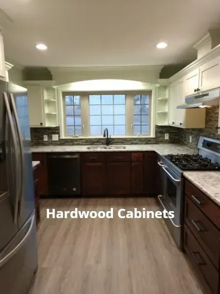 Modern kitchen with dark hardwood cabinets, stainless appliances, and a large window over the sink
