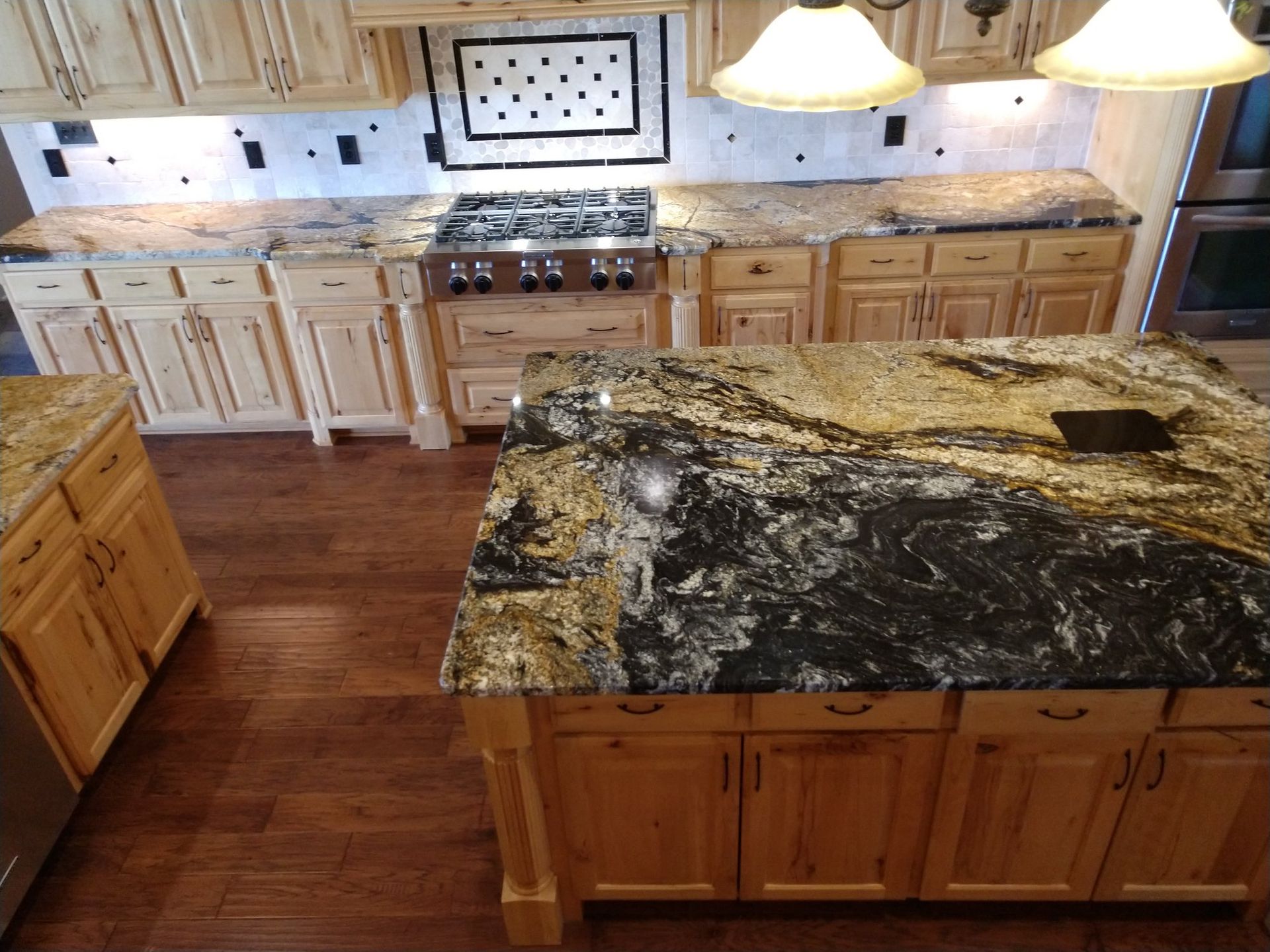 A kitchen with granite counter tops and wooden cabinets