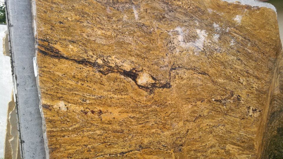 A large piece of granite is sitting on top of a concrete surface.