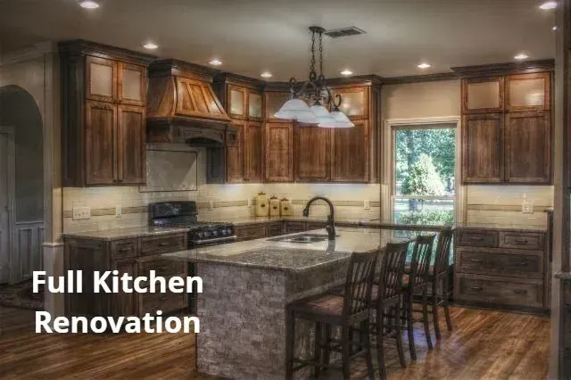 Spacious remodeled kitchen with dark wood cabinets, granite island, and pendant lights