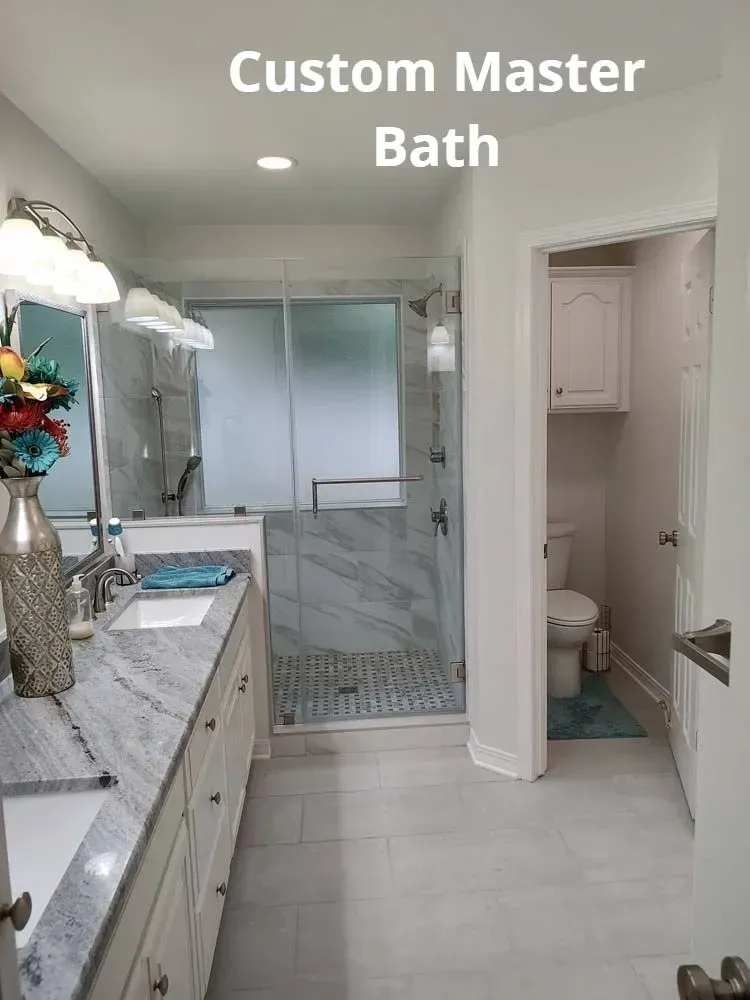 Bright custom master bathroom with double vanity, glass shower, and toilet room