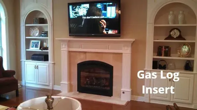 Living room with wall-mounted TV above a white fireplace and a gas log insert, with built-in shelves on both sides.