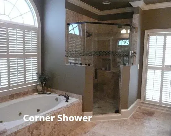 Corner shower with glass enclosure beside a beige bathtub in a bright bathroom.
