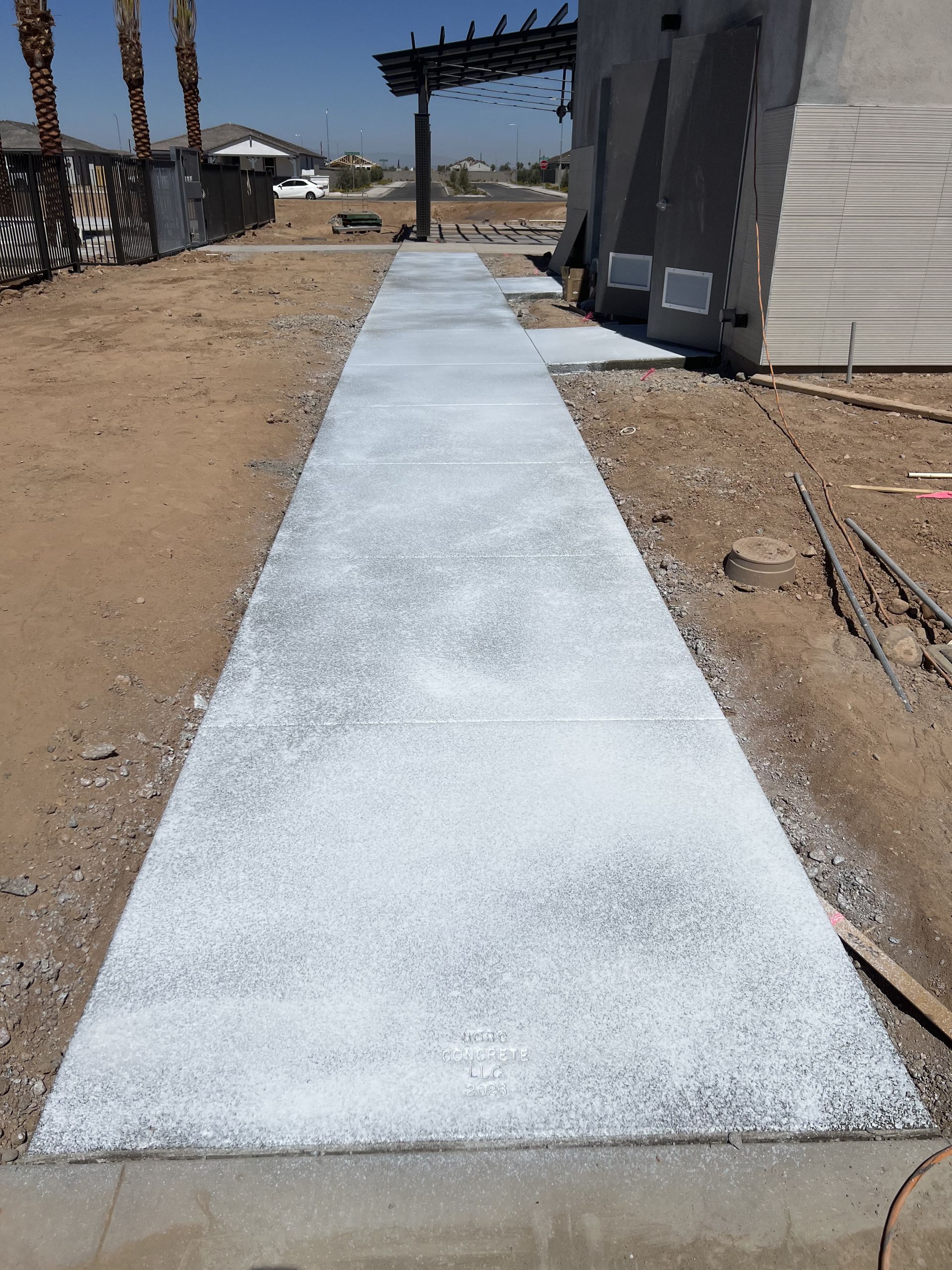 Concrete sidewalk beside a commercial building
