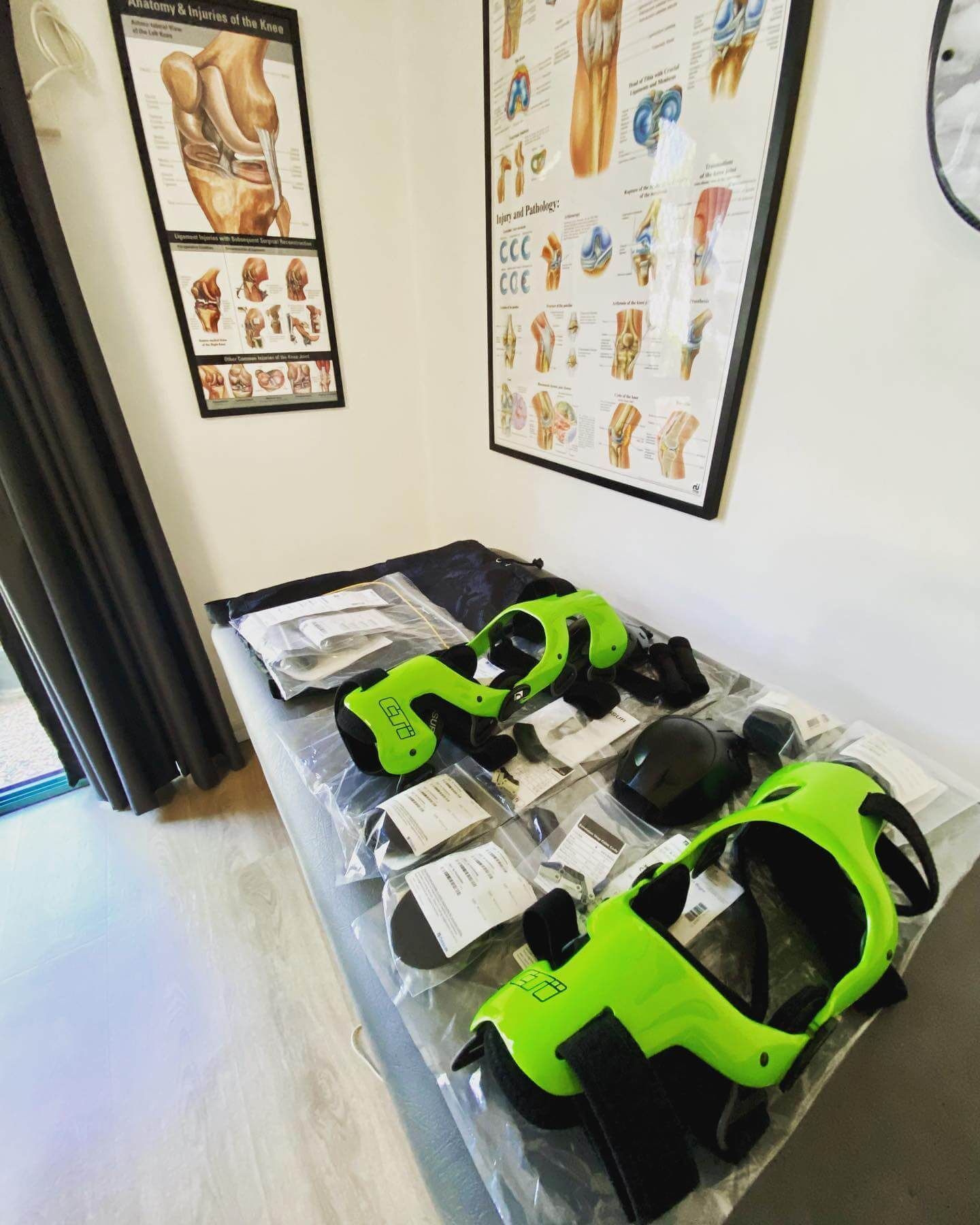 Two Green Knee Braces Are Sitting on a Table in a Room — Gall Bros Medical in Gold Coast, QLD