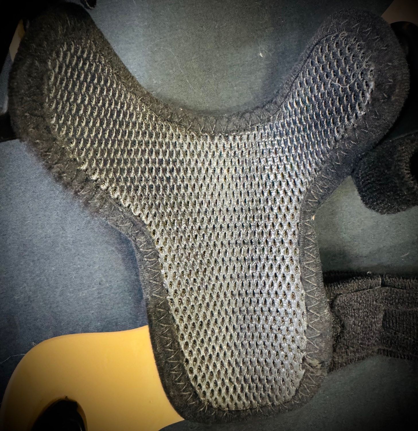 Gray Mesh Car Seat Cover With a Yellow Section on a Dark Seat — Gall Bros Medical in Robina, QLD
