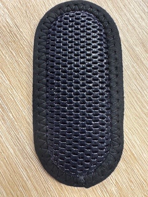 Black Oval Mesh Pad on a Light Wood Surface — Gall Bros Medical in Robina, QLD