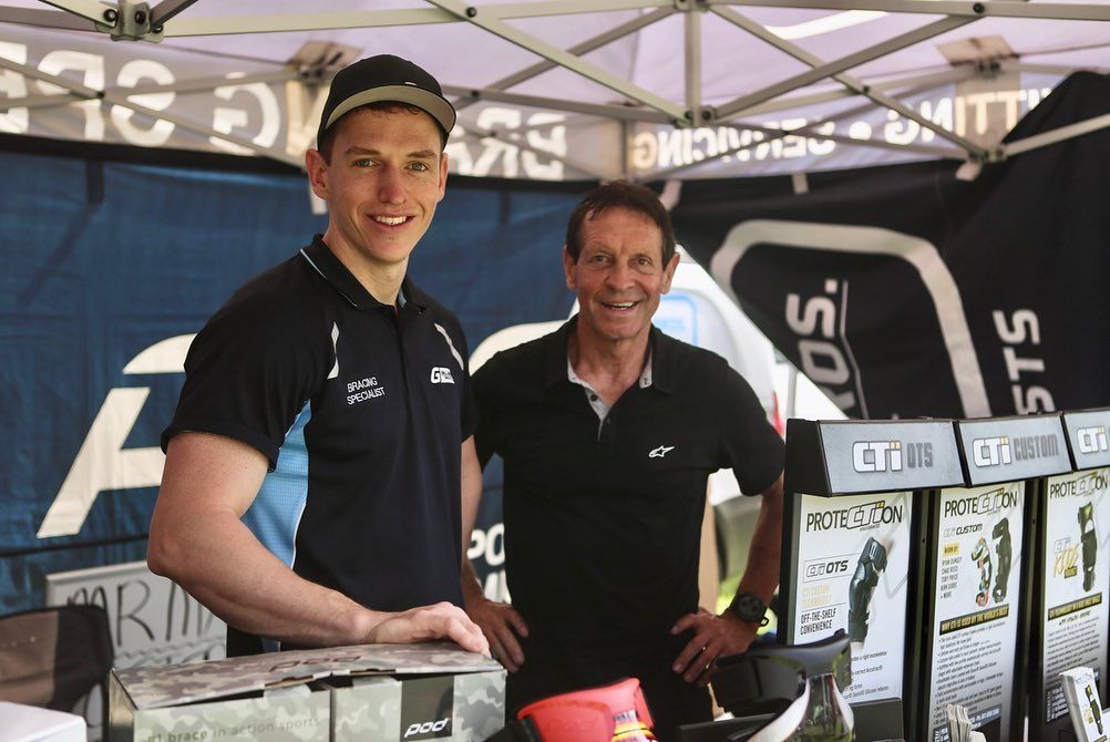 Two Men Standing Next to Each Other in Front of a Tent — Gall Bros Medical in Robina, QLD