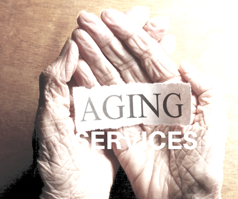 Hands cupping the words “AGING SERVICES” on a warm beige background