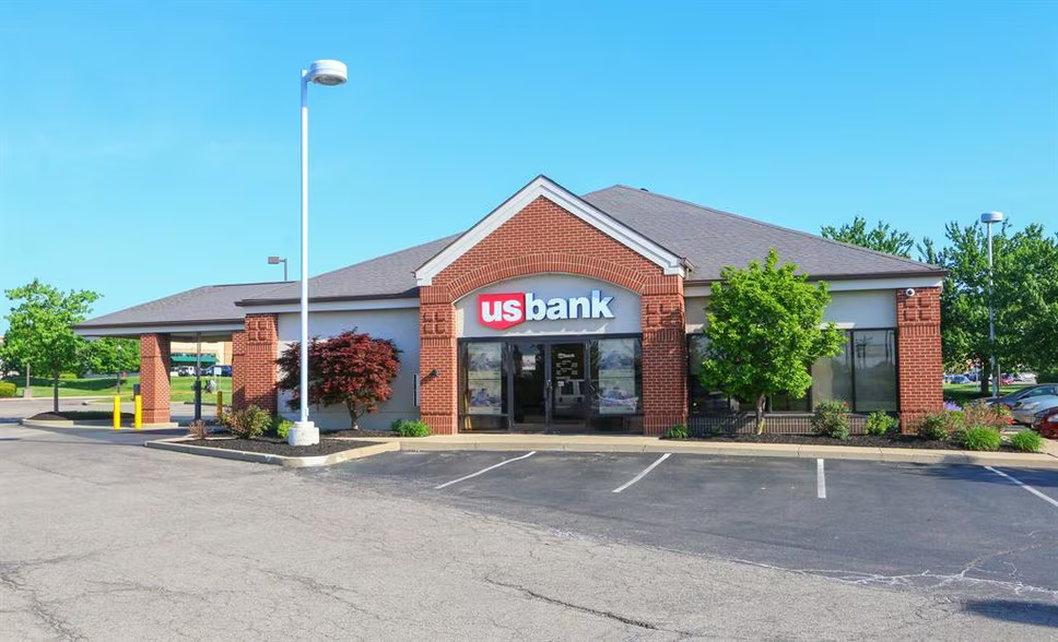 US Bank branch building exterior, red brick and gray, on a sunny day.