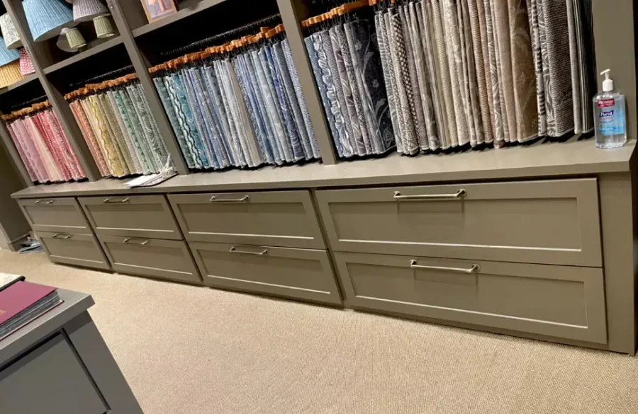 There are many different types of fabrics on the shelves in this room.