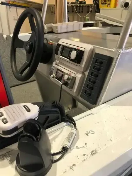 A Boat With A Steering Wheel And A Remote Control On It — REM Auto Electrics In Wallsend, NSW
