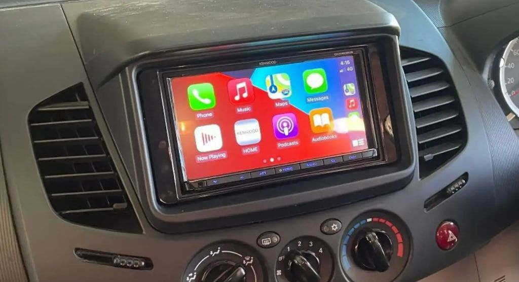 A Car Dashboard With A Radio And A Phone On It — REM Auto Electrics In Newcastle, NSW