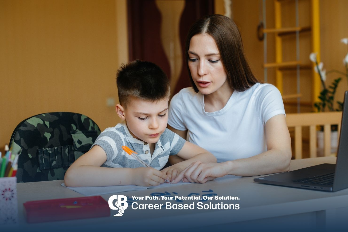 Therapist supporting an autistic kid during homework time while encouraging focus during therapy