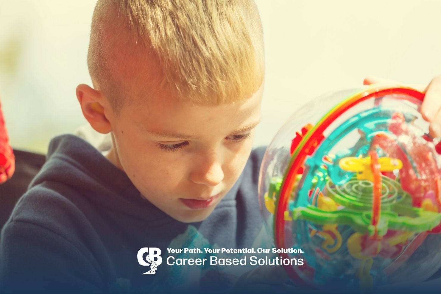 Autistic kid exploring a colorful sensory toy while focusing on play activity & developing sensory