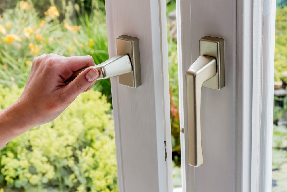 woman opens a window to ventilate
