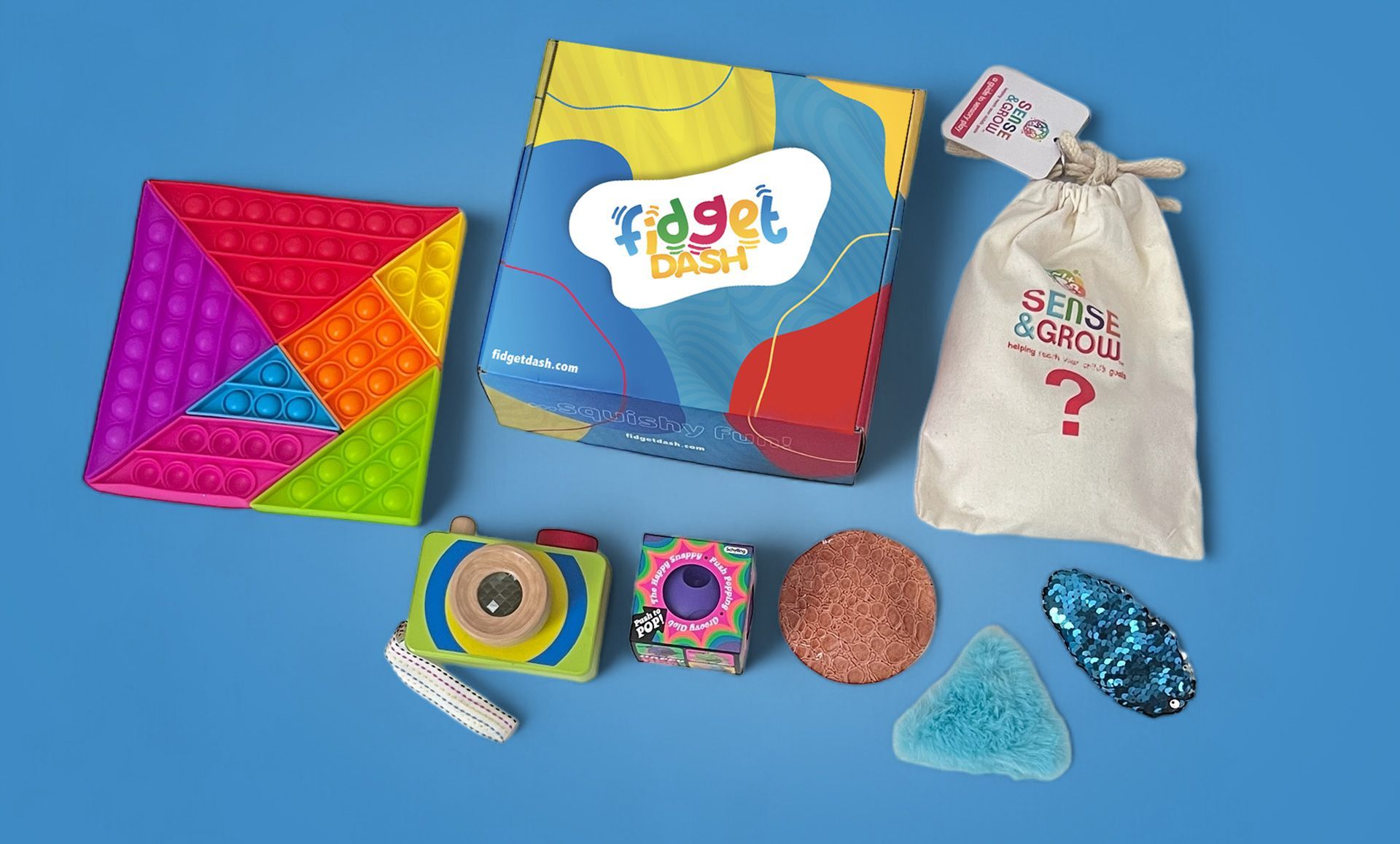 A fidget dash box of sensory  fidget toys is sitting on a blue table.