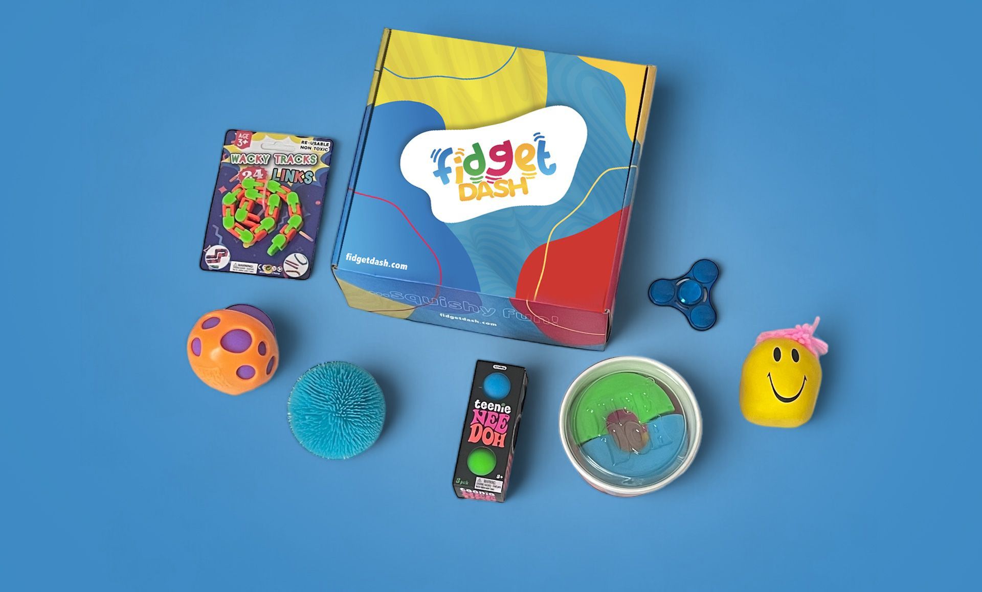 A box of fidget dash sensory  toys is sitting on a blue surface.