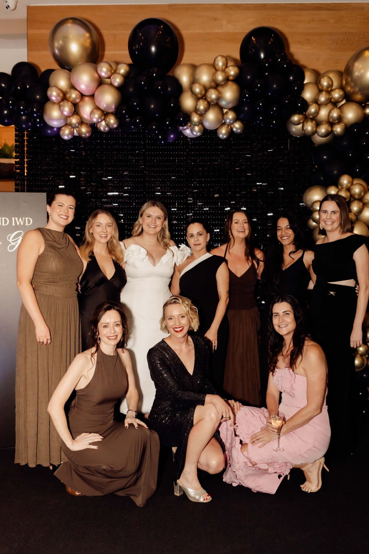 Women posing in front of the balloon arch at the EverLend International Women's Day Charity Gala
