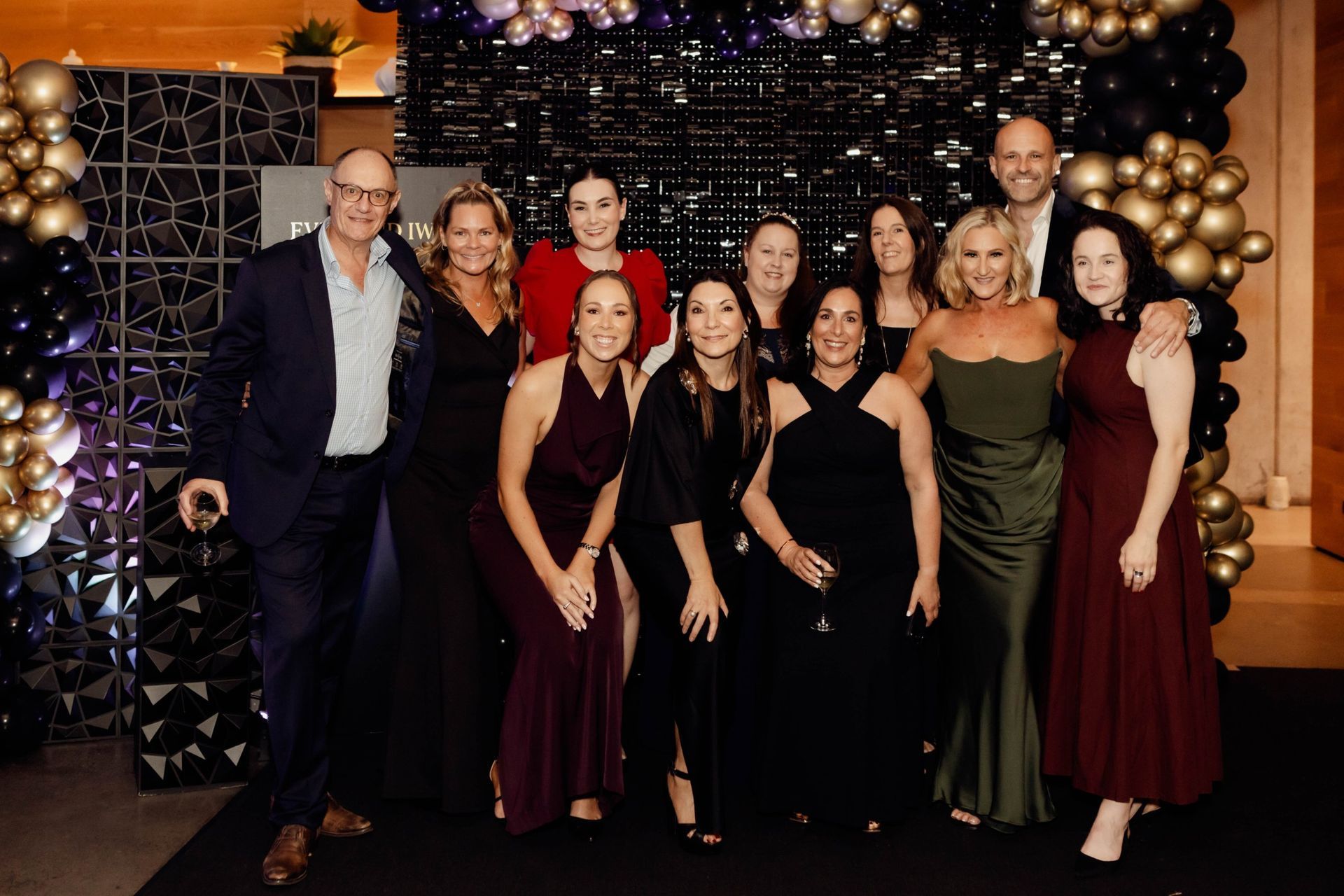 Group of guests at the balloon arch at the EverLend International Women's Day Charity Gala