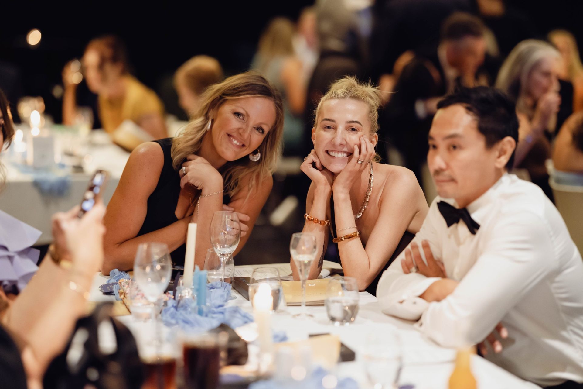 Guests smiling at their table at the EverLend International Women's Day Charity Gala